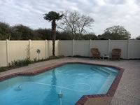 6 foot tall solid vinyl privacy fence around a pool area