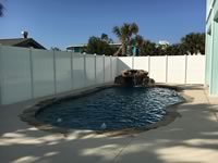 8 foot tall solid vinyl privacy fence enclosing a pool area