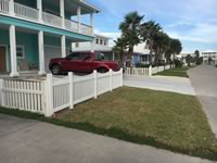 Vinyl concave picket fence and vinyl banister on a coastal home